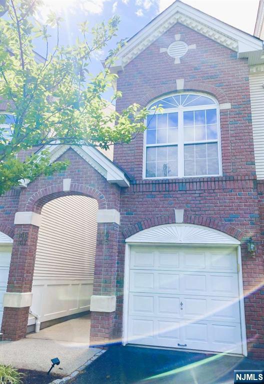 145 Riverwalk Way, Clifton, NJ 07014 - view of front of home with brick siding and a garage