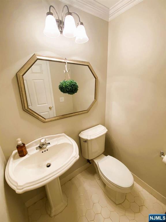 145 Riverwalk Way, Clifton, NJ 07014 - half bathroom with toilet, baseboards, crown molding, a chandelier, and tile patterned floors