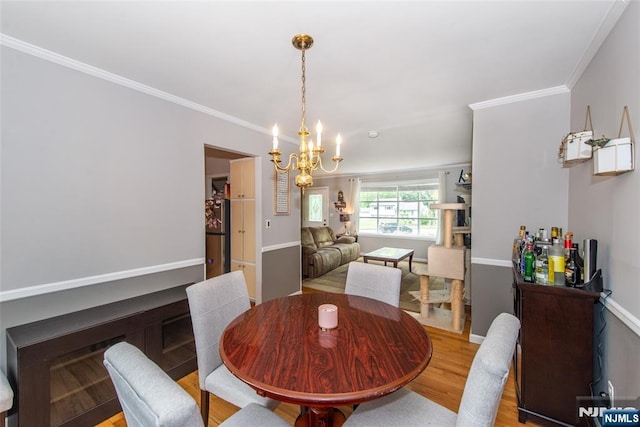 60 Lyon Rd, Waldwick, NJ 07463 - dining space with wood finished floors, a chandelier, and crown molding