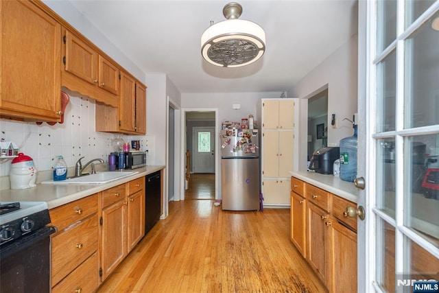 60 Lyon Rd, Waldwick, NJ 07463 - kitchen featuring appliances with stainless steel finishes, light countertops, light wood-style flooring, and backsplash