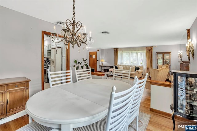 42 Cecilia Dr, Wayne, NJ 07470 - dining area featuring a chandelier and light wood-style flooring