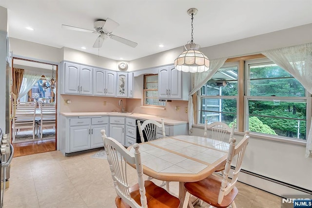 42 Cecilia Dr, Wayne, NJ 07470 - dining area with healthy amount of natural light, a ceiling fan, baseboard heating, and light tile patterned floors