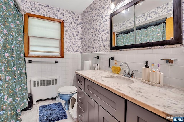 42 Cecilia Dr, Wayne, NJ 07470 - bathroom with radiator heating unit, wallpapered walls, vanity, toilet, and wainscoting