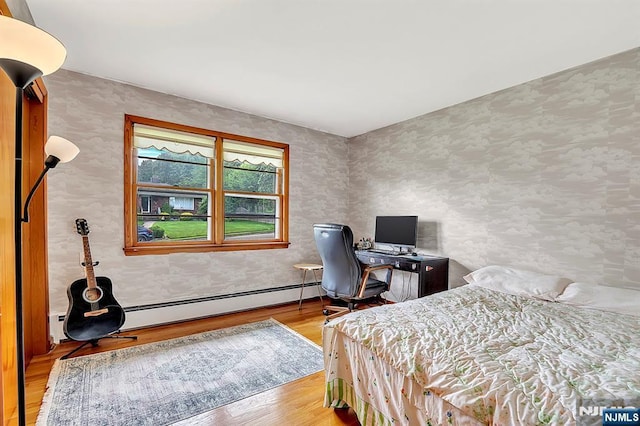 42 Cecilia Dr, Wayne, NJ 07470 - bedroom with wood finished floors, wallpapered walls, and a baseboard radiator