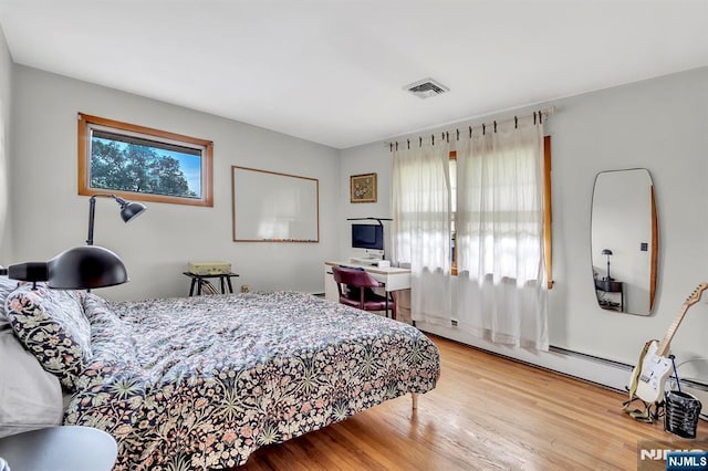 42 Cecilia Dr, Wayne, NJ 07470 - bedroom with multiple windows, wood finished floors, and a baseboard radiator