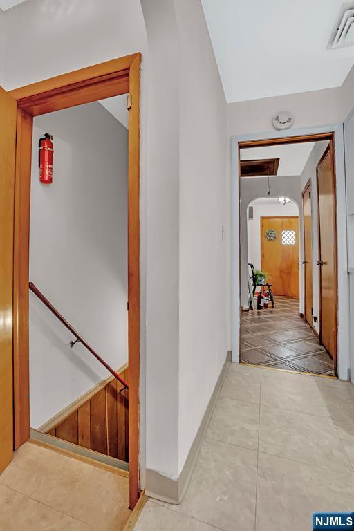 42 Cecilia Dr, Wayne, NJ 07470 - hall with attic access, tile patterned floors, and baseboards