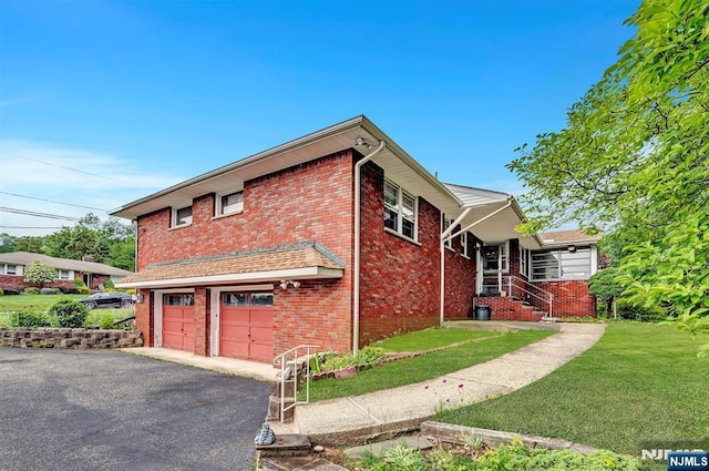 42 Cecilia Dr, Wayne, NJ 07470 - view of home's exterior featuring brick siding, asphalt driveway, a lawn, and a garage