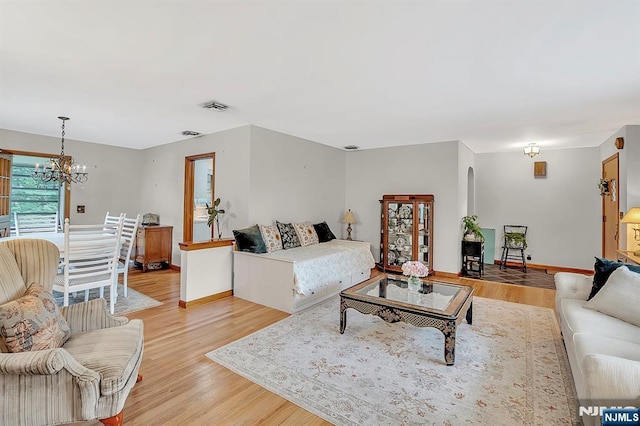 42 Cecilia Dr, Wayne, NJ 07470 - living room featuring a chandelier, light wood-style floors, and baseboards