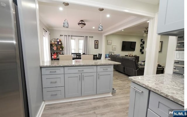 516 Beardsley Ave, Bloomfield, NJ 07003 - kitchen with freestanding refrigerator, ceiling fan, a peninsula, crown molding, and light stone counters