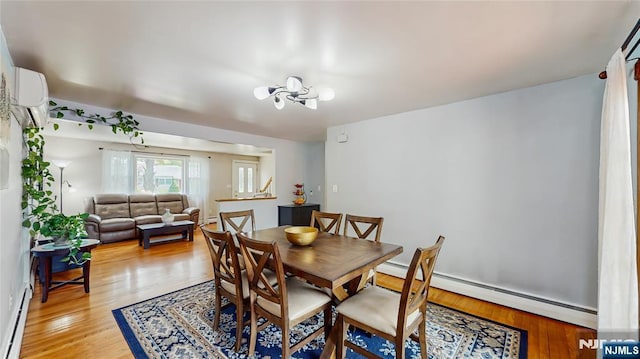 336 Ridgewood Blvd, Twp Of Washington, NJ 07676 - dining area with a baseboard heating unit, light wood finished floors, a wall unit AC, and a chandelier