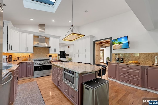18 Lomas Ln, Montvale, NJ 07645 - kitchen with appliances with stainless steel finishes, backsplash, white cabinetry, a skylight, and recessed lighting