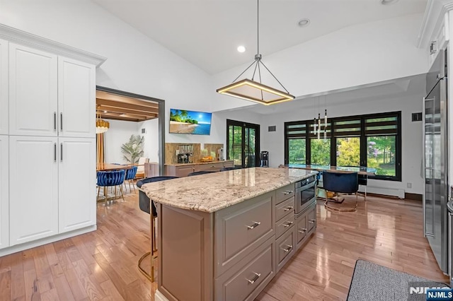 18 Lomas Ln, Montvale, NJ 07645 - kitchen featuring light wood-type flooring, gray cabinetry, vaulted ceiling, a center island, and white cabinetry
