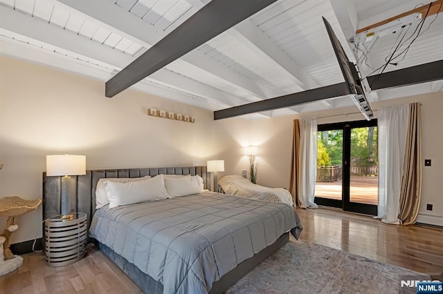 18 Lomas Ln, Montvale, NJ 07645 - bedroom with access to exterior, light wood-style floors, and beamed ceiling