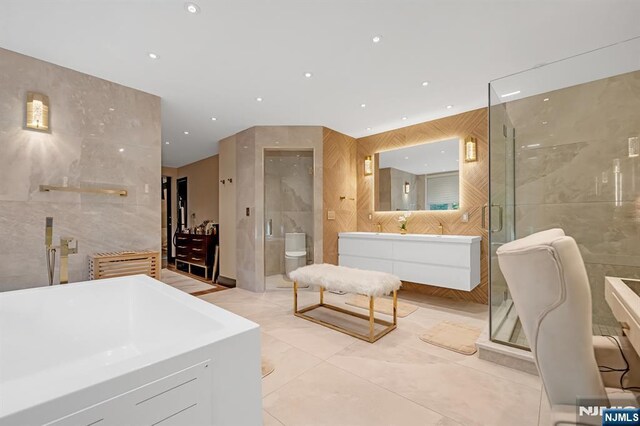 18 Lomas Ln, Montvale, NJ 07645 - full bath featuring tile walls, a stall shower, a freestanding bath, vanity, and recessed lighting