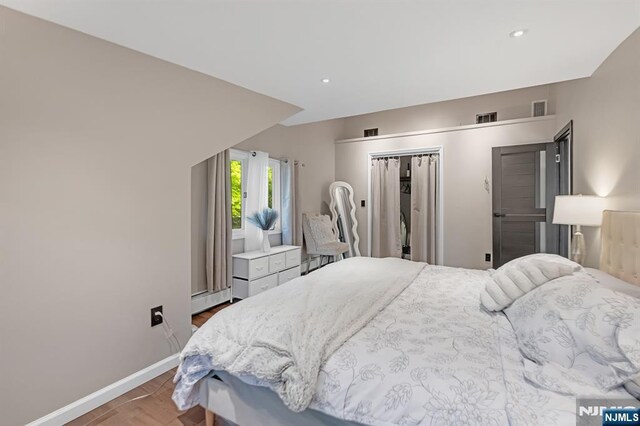 18 Lomas Ln, Montvale, NJ 07645 - bedroom featuring baseboards, a baseboard radiator, wood finished floors, recessed lighting, and a closet