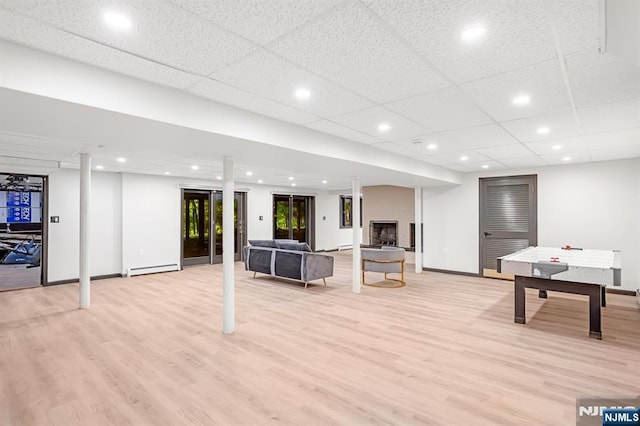 18 Lomas Ln, Montvale, NJ 07645 - unfurnished living room featuring light wood-style floors, baseboards, recessed lighting, a fireplace, and a baseboard heating unit