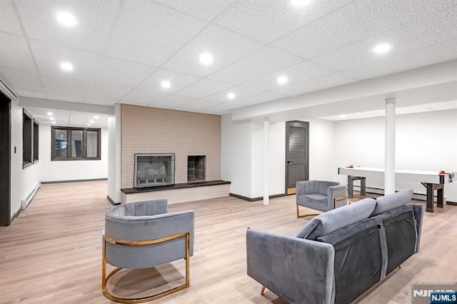 18 Lomas Ln, Montvale, NJ 07645 - living area with a baseboard heating unit, baseboards, light wood finished floors, a fireplace, and recessed lighting