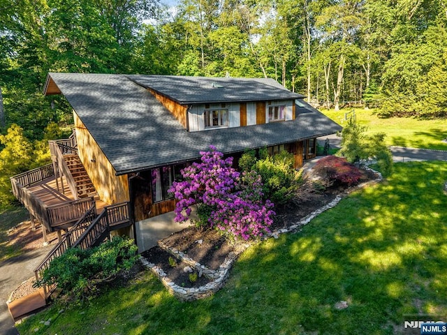 18 Lomas Ln, Montvale, NJ 07645 - view of front of property with stairway, a front lawn, covered porch, roof with shingles, and a wooded view