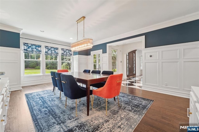 1021 Hillcrest Rd, Ridgewood, NJ 07450 - dining space with a decorative wall, arched walkways, crown molding, a chandelier, and wood finished floors