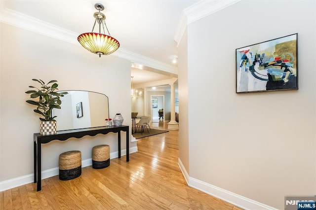 308 Holly Ln Unit 32, Cedar Grove, NJ 07009 - hallway with ornamental molding, light wood-style flooring, a chandelier, decorative columns, and baseboards