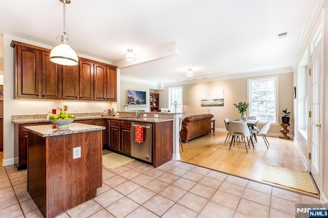308 Holly Ln Unit 32, Cedar Grove, NJ 07009 - kitchen featuring dishwasher, a peninsula, a center island, open floor plan, and light stone countertops