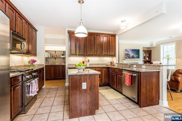 308 Holly Ln Unit 32, Cedar Grove, NJ 07009 - kitchen featuring appliances with stainless steel finishes, a sink, a peninsula, a center island, and light stone counters