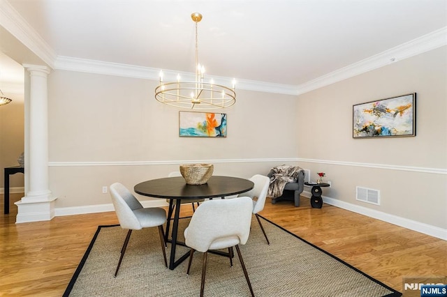 308 Holly Ln Unit 32, Cedar Grove, NJ 07009 - dining area featuring decorative columns, crown molding, light wood-style floors, and baseboards