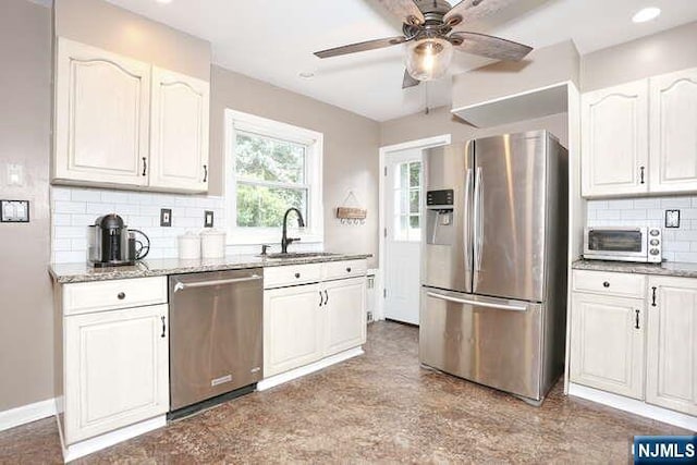 2 Hartland Ave, Emerson, NJ 07630 - kitchen with stainless steel appliances, a sink, light stone counters, a ceiling fan, and recessed lighting