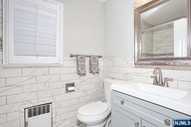 2 Hartland Ave, Emerson, NJ 07630 - full bathroom with radiator, toilet, vanity, a shower, and tile walls