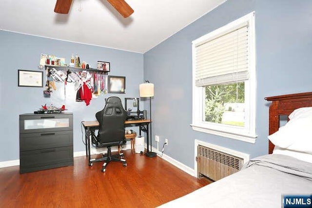 2 Hartland Ave, Emerson, NJ 07630 - bedroom with radiator, wood finished floors, a desk, baseboards, and a ceiling fan