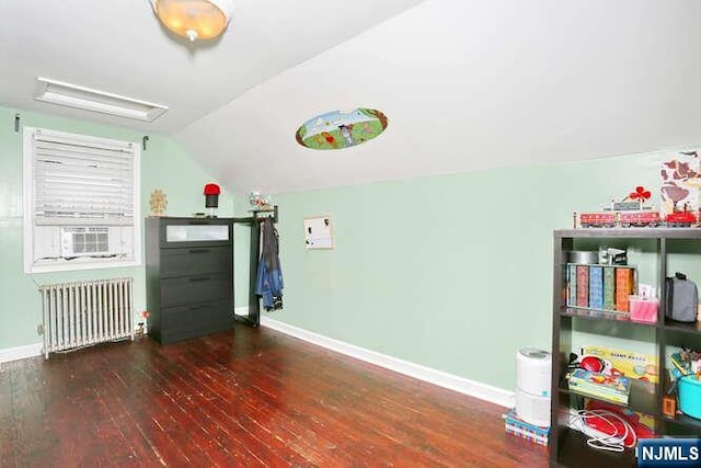 2 Hartland Ave, Emerson, NJ 07630 - playroom with radiator, wood-type flooring, baseboards, lofted ceiling, and attic access