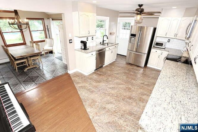2 Hartland Ave, Emerson, NJ 07630 - kitchen with stainless steel appliances, a sink, white cabinets, a ceiling fan, and recessed lighting