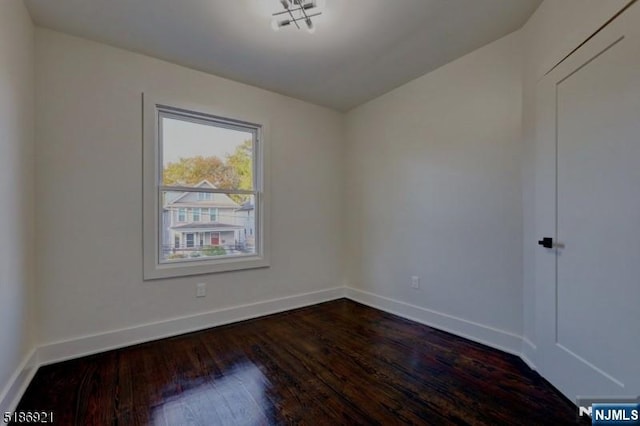 46 Rutgers Pl, Passaic, NJ 07055 - unfurnished room with dark wood-style flooring and baseboards