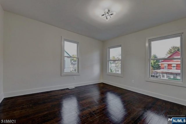 46 Rutgers Pl, Passaic, NJ 07055 - spare room with baseboards and dark wood-style flooring