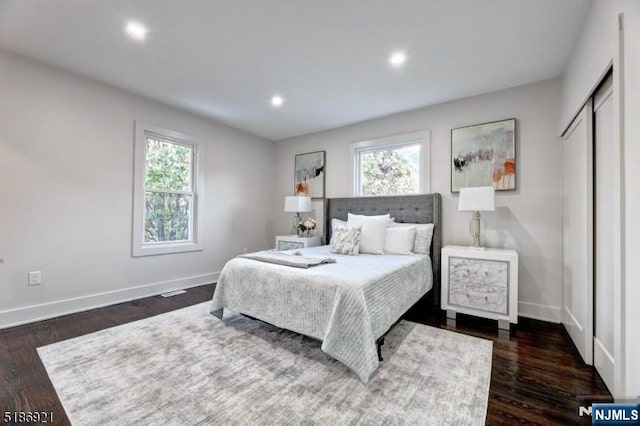 46 Rutgers Pl, Passaic, NJ 07055 - bedroom with multiple windows, baseboards, dark wood-type flooring, and recessed lighting