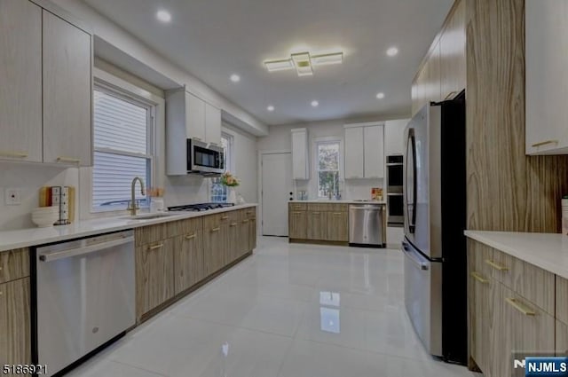 46 Rutgers Pl, Passaic, NJ 07055 - kitchen featuring appliances with stainless steel finishes, a sink, modern cabinets, light countertops, and recessed lighting