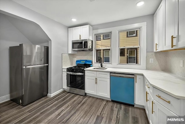 27 Berkeley Pl, Bloomfield, NJ 07003 - kitchen with stainless steel appliances, a sink, dark wood-style flooring, decorative backsplash, and white cabinets