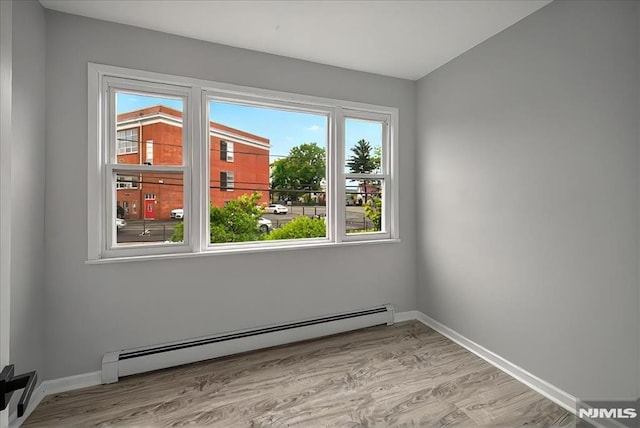 27 Berkeley Pl, Bloomfield, NJ 07003 - spare room featuring a baseboard radiator, healthy amount of natural light, and light wood-style floors