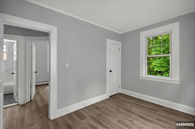 27 Berkeley Pl, Bloomfield, NJ 07003 - unfurnished room featuring ornamental molding, a baseboard heating unit, baseboards, and wood finished floors