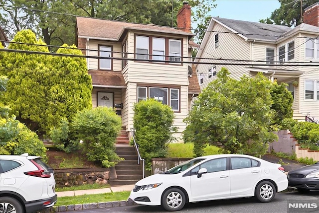 27 Berkeley Pl, Bloomfield, NJ 07003 - view of front facade with stairway and a chimney