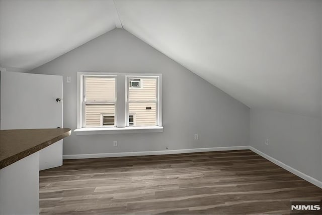 27 Berkeley Pl, Bloomfield, NJ 07003 - bonus room with vaulted ceiling, dark wood finished floors, and baseboards