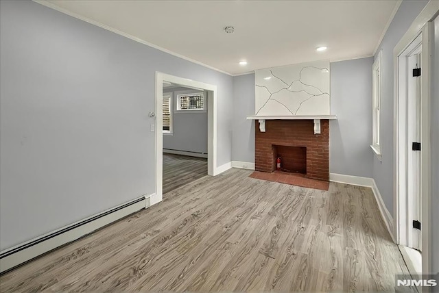 27 Berkeley Pl, Bloomfield, NJ 07003 - unfurnished living room with a baseboard radiator, crown molding, light wood finished floors, baseboards, and recessed lighting