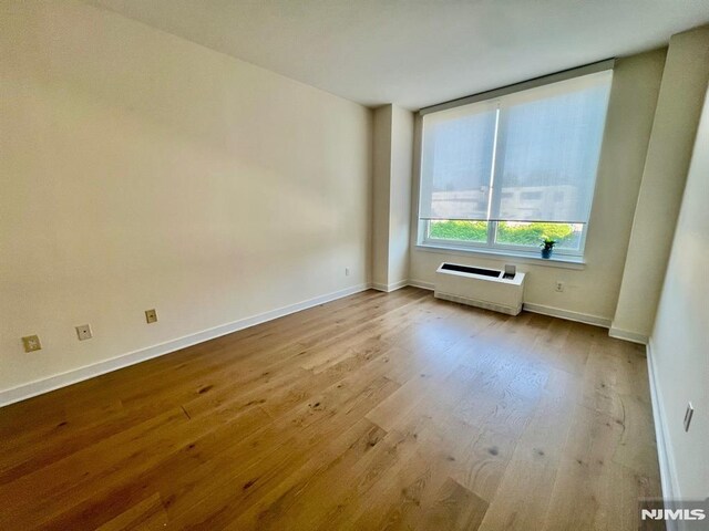 800 12th St Unit 207, Palisades Park, NJ 07650 - unfurnished room with wood finished floors and baseboards