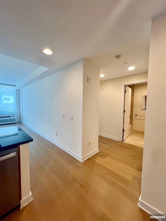 800 12th St Unit 207, Palisades Park, NJ 07650 - unfurnished dining area with light wood-style flooring, baseboards, and recessed lighting