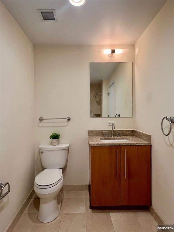 800 12th St Unit 207, Palisades Park, NJ 07650 - bathroom featuring vanity, baseboards, and toilet