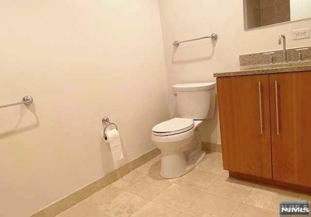 800 12th St Unit 207, Palisades Park, NJ 07650 - bathroom with vanity, toilet, baseboards, and tile patterned flooring