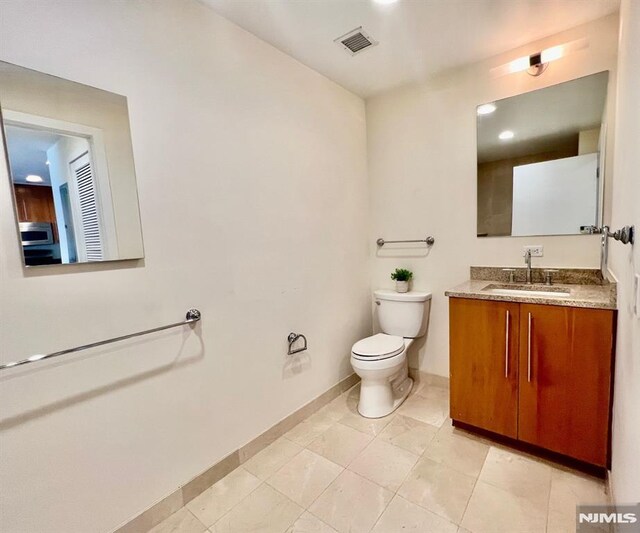 800 12th St Unit 207, Palisades Park, NJ 07650 - bathroom featuring toilet, vanity, and baseboards
