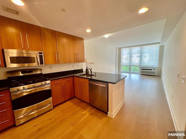 800 12th St Unit 207, Palisades Park, NJ 07650 - kitchen featuring stainless steel appliances, a sink, light wood-type flooring, dark countertops, and recessed lighting