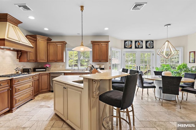 6 Lauren Pond Ct, Demarest, NJ 07627 - kitchen with stone tile floors, premium range hood, backsplash, recessed lighting, and a kitchen breakfast bar
