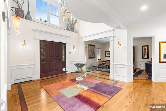 6 Lauren Pond Ct, Demarest, NJ 07627 - foyer with ornate columns, a baseboard radiator, ornamental molding, wood finished floors, and a decorative wall